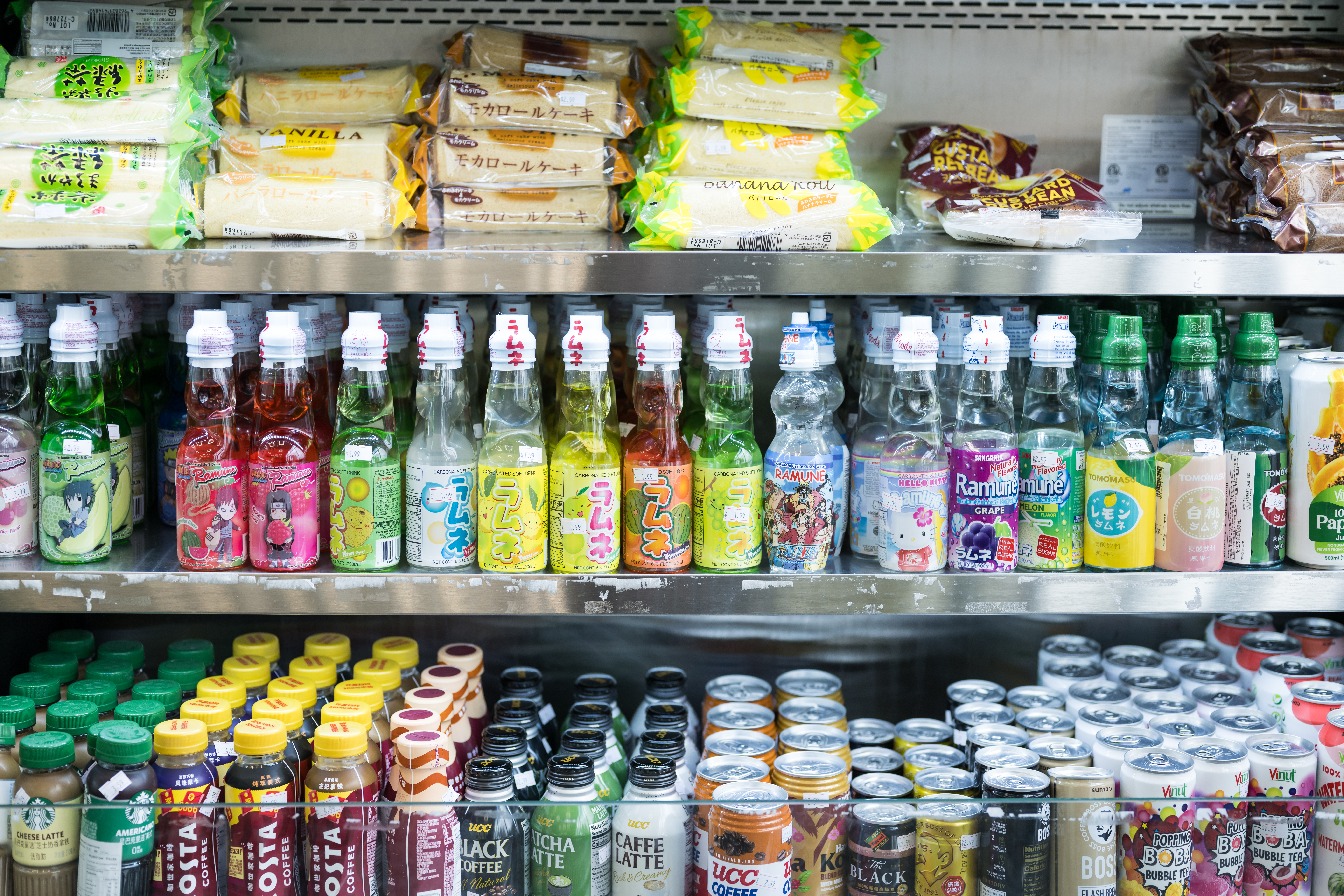 Shelved stocked with an array of Asian drinks and food.