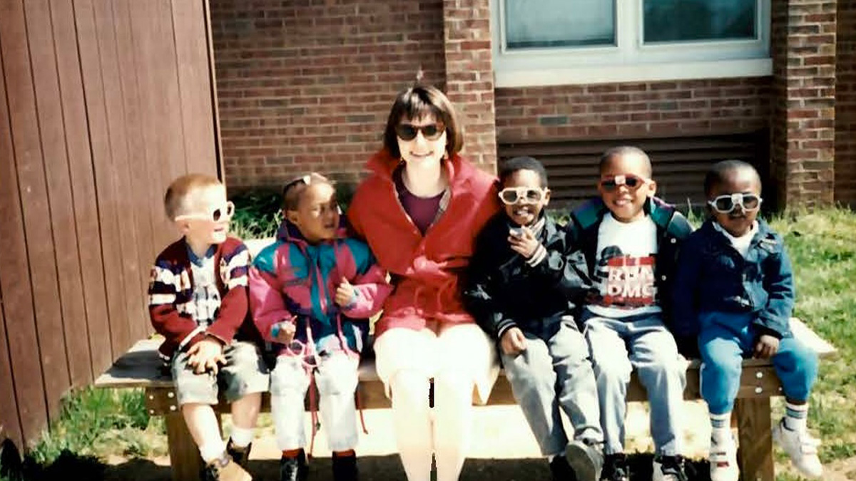 Martha Mock early in her career as an early childhood teacher in Virginia sitting with her students outside of school.