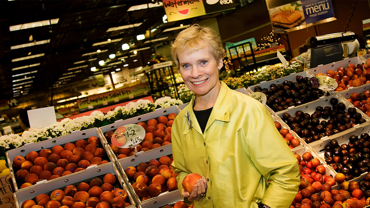 Mary Ellen Burris standing in the produce section of Wegmans
