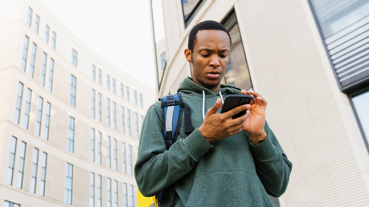 Male college student looking at his phone