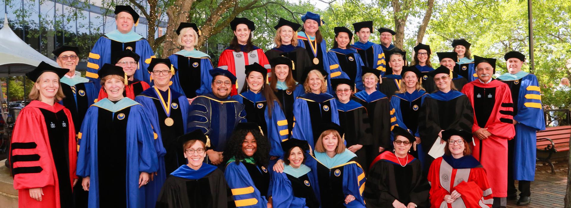Warner School group faculty photo at 2024 commencement 