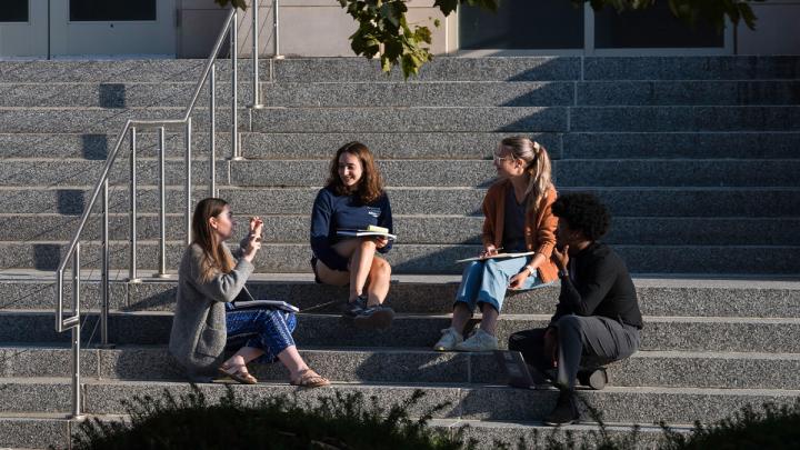 Students sitting on front steps of LeChase Hall